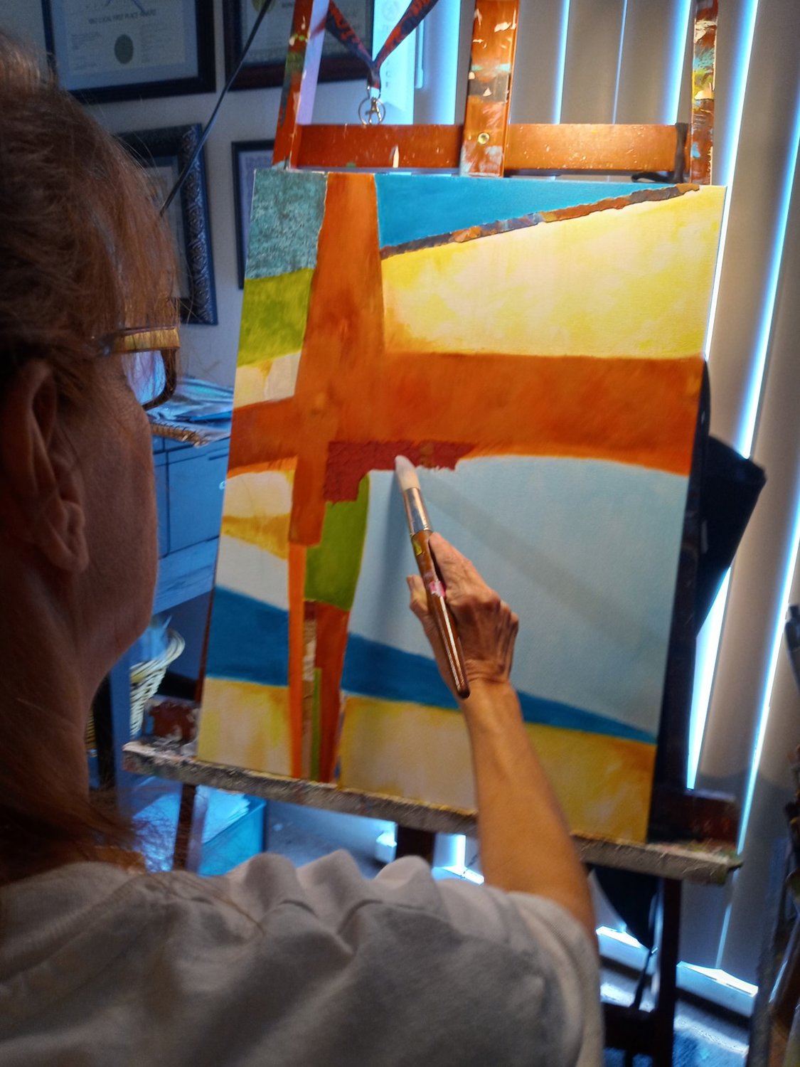 Cyndi Horn crates one of her cruciform paintings.